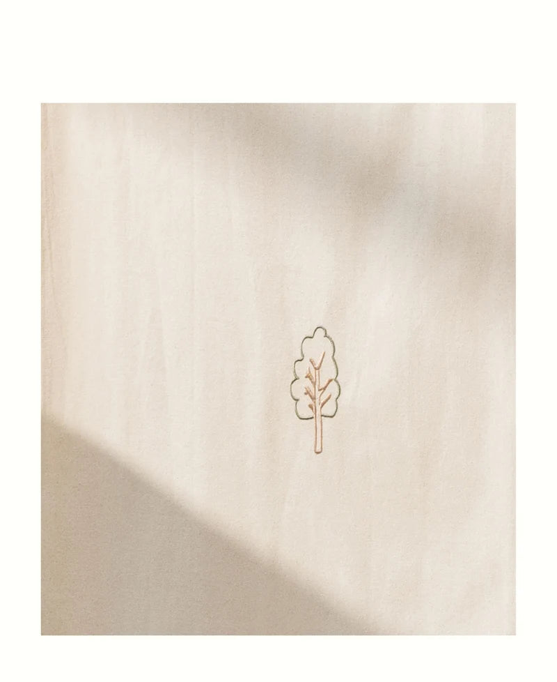 A square beige fabric of the house bed canopy with a small minimalist tree outline printed in the center, shown against a white background with soft shadow overlays.