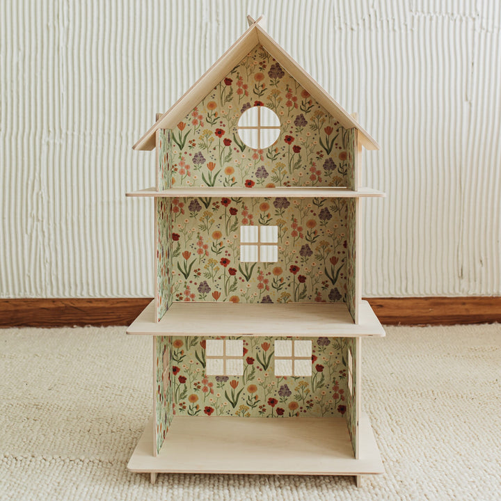 wooden doll house with meadow floral design inside on the walls 
