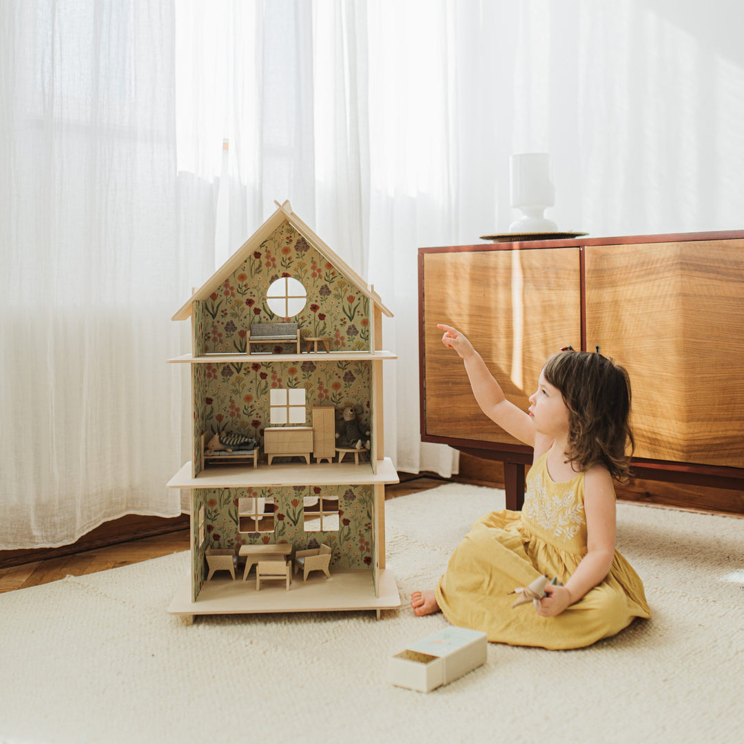 Child playing with a Wooden Dollhouse and Maileg Mice